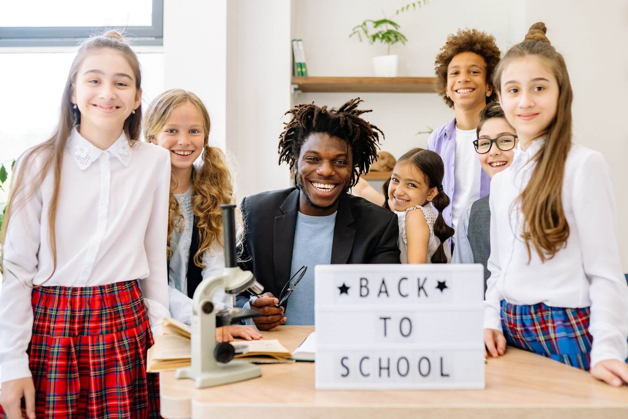 Teacher smiling with engaged elementary students in class